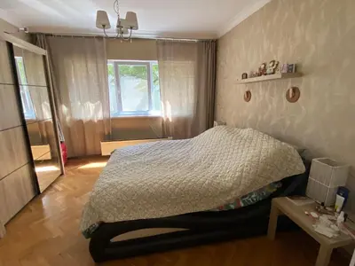 a bedroom with a bed and a window and a table at Journalist squad in Sofia
