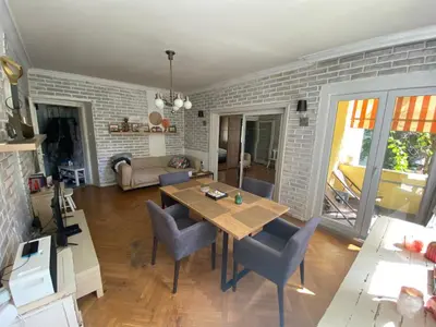 a living room with a wooden table and chairs at Journalist squad in Sofia