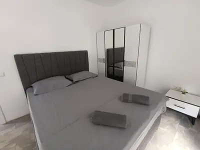 a bedroom with a large bed and a mirror at Green Apart Residence Including Parking Place in Sofia