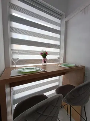 a table with two glasses and two chairs at Green Apart Residence Including Parking Place in Sofia