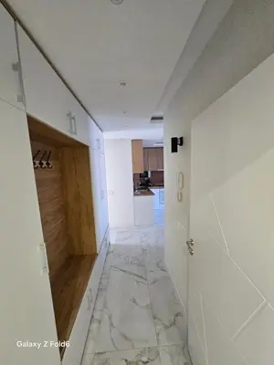 an empty hallway with a door and a kitchen at Dilyanka 3 in Pernik