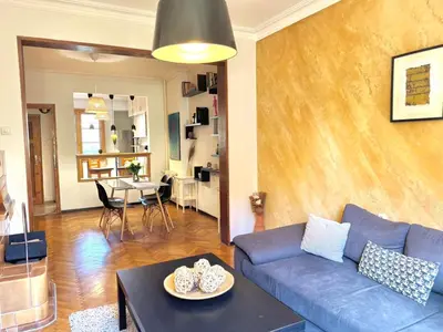a living room with a blue couch and a table at Boby Center Home in Sofia