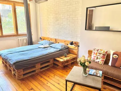 a bedroom with a bed and a couch at Boby Center Home in Sofia