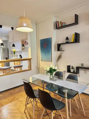 a dining room with a glass table and chairs at Boby Center Home in Sofia