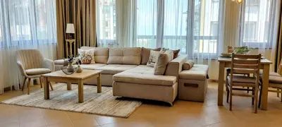 a living room with a couch and a table at Nature Escape to Pirin Golf in Razlog