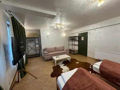 a living room with two beds and a couch at Just a Dream - guest apartments in Troyan