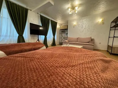 a bedroom with a large bed and a couch at Just a Dream - guest apartments in Troyan