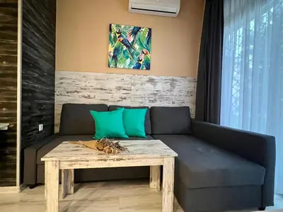 a living room with a couch and a table at Flower house 1 in Sofia