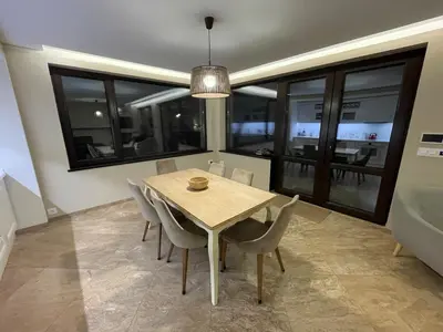 a dining room with a table and chairs at Premium Studio Apartment in Private Villa Nisim in Batak