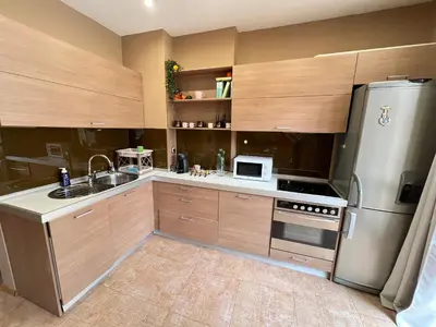 a kitchen with wooden cabinets and a stainless steel refrigerator at Hamburg 100 Sq M 2BDR Family Apt near NDK and Vitosha BLVD in Sofia