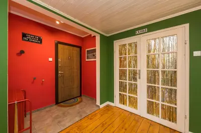 a room with green and red walls and a door at Cozy family loft at Women's market in Sofia