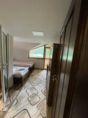 a room with a room with a bed and a window at Къща за гости Кристияна in Devin