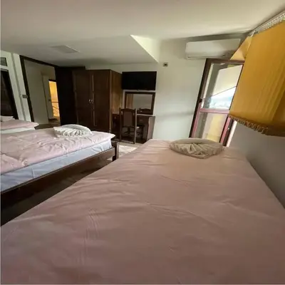 a bedroom with two beds in a room at Къща за гости Кристияна in Devin