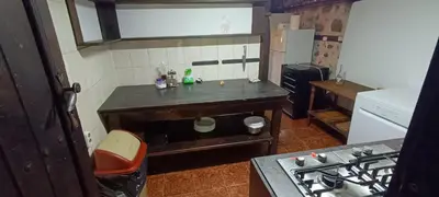 a small kitchen with a counter and a stove at Къща за гости- Шале Мила in Bansko