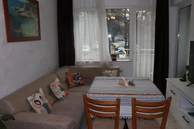 a living room with a couch and a table at Комфортен апартамент, безплатно гараж! in Sofia