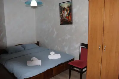 a bedroom with a bed and a red chair at Комфортен апартамент, безплатно гараж! in Sofia