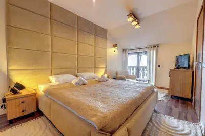 a bedroom with a large bed in a room at Luxury 1BD Retreat in Grand Resort Pamporovo by Flat Manаger in Pamporovo