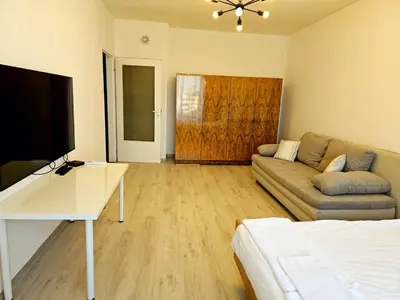 a living room with a couch and a television at Ortakchiev 3 in Sofia