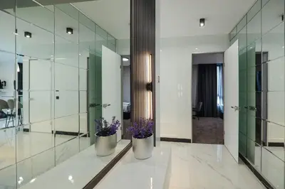 a bathroom with two vases with purple flowers in it at Home Lux in Gotse Delchev