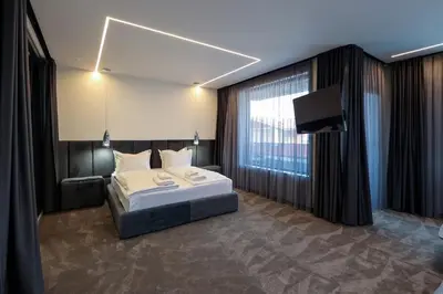 a bedroom with a bed and a flat screen tv at Home Lux in Gotse Delchev