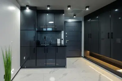 a black kitchen with black cabinets and a sink at Home Lux in Gotse Delchev