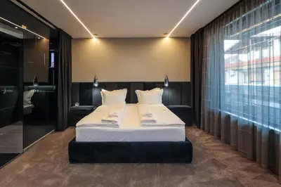 a bedroom with a bed and a large window at Home Lux in Gotse Delchev