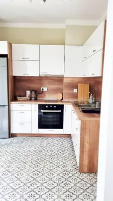 a kitchen with white cabinets and a tile floor at No X - Sofia top center in Sofia