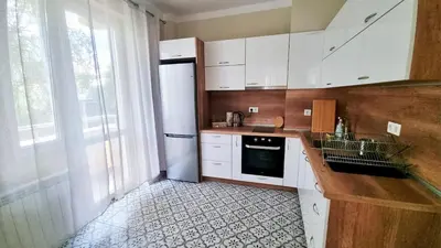 a kitchen with white cabinets and a sink and a refrigerator at No X - Sofia top center in Sofia