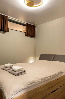 a bedroom with a bed with towels on it at Incredible 2BDR with Veranda and House-like Feel in Bansko