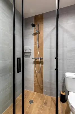 a bathroom with a shower stall and a toilet at Incredible 2BDR with Veranda and House-like Feel in Bansko