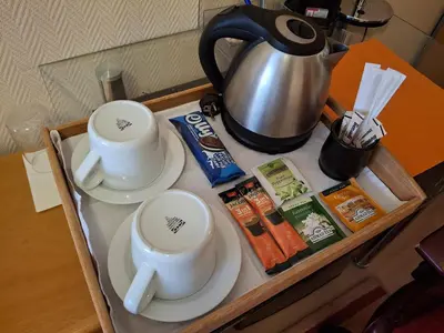 a tray with two cups and a tea pot on it at Stay with Me Women only room parking childrens pets welcom in Sofia