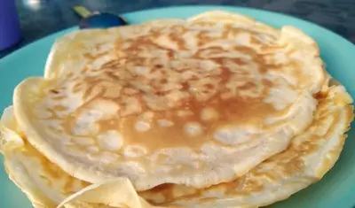 a stack of pancakes on a blue plate at Stay with Me Women only room parking childrens pets welcom in Sofia