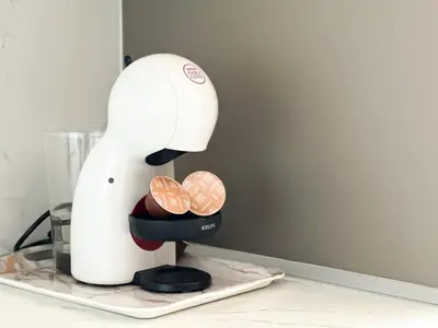 a white mixer sitting on a counter with coins in it at Modern 1BD Near Paradise Center & Vitosha Metro by Flat Manager in Sofia