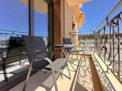 a balcony with two chairs and a table at Modern 1BD Near Paradise Center & Vitosha Metro by Flat Manager in Sofia