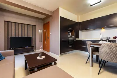 a living room with a couch and a dining room at Modern 2BD - 14 min to Medical University by Flat Manager in Plovdiv