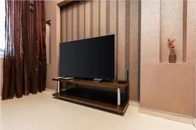 a flat screen tv sitting on a stand in a room at Modern 2BD - 14 min to Medical University by Flat Manager in Plovdiv