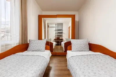 a living room with two beds and a mirror at Modern 2BD - 14 min to Medical University by Flat Manager in Plovdiv