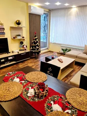 a living room with a christmas tree on a table at Bright 70 m2 Family Apt, Center Sofia, Metro, Parking in Sofia