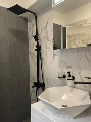 a bathroom with a white sink and a mirror at Sofia City Quiet Retreat in Sofia