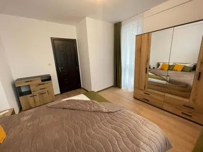 a bedroom with a large bed and a dresser at Sofia City Quiet Retreat in Sofia
