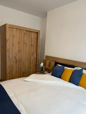 a bedroom with a large bed with yellow and blue pillows at Sofia City Quiet Retreat in Sofia