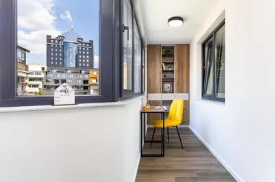 a room with a window and a table with a yellow chair at Two Stylish 1BD Apartments with Desk in Karshiaka by Flat Manager in Plovdiv