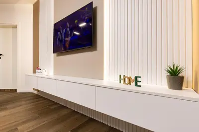 a long white bench in a room with a tv on the wall at Two Stylish 1BD Apartments with Desk in Karshiaka by Flat Manager in Plovdiv