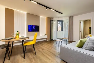 a living room with a couch and a table at Two Stylish 1BD Apartments with Desk in Karshiaka by Flat Manager in Plovdiv