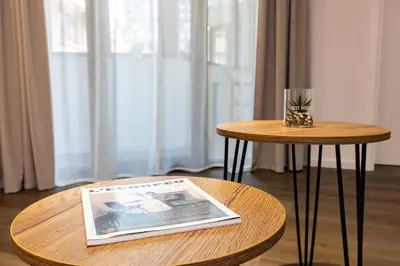 a table with a magazine and a table with a newspaper on it at Two Stylish 1BD Apartments with Desk in Karshiaka by Flat Manager in Plovdiv