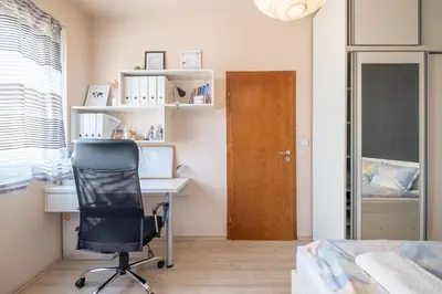 a bedroom with a desk and a chair and a door at Modern Apartment - Top Location - Friendly Host by Flat Manager in Sofia