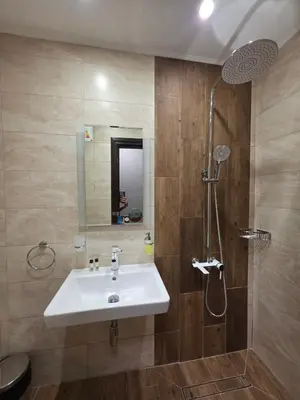 a bathroom with a sink and a shower at Хотел Ресторант Ваката in Teteven