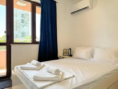 a bedroom with a bed with towels on it at 1BR Apartment with a Designated Workspace, Free Street Parking and Free Gym Pass in Plovdiv