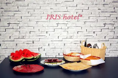 a table with plates of watermelon and baskets of food at Hotel Iris in Plovdiv
