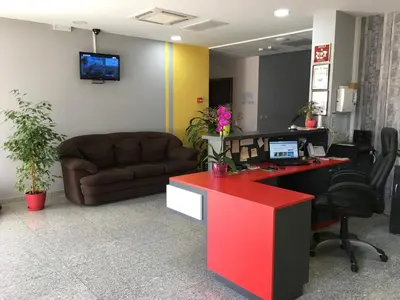 an office with a couch and a desk with a computer at Hotel Iris in Plovdiv